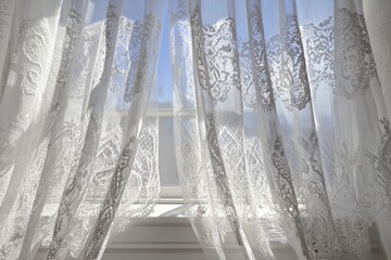 Delicate white lace curtains billowing at a window, letting sunlight through