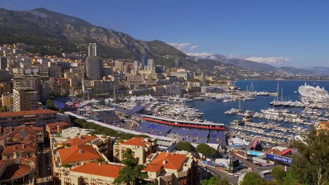 A stunning aerial timelapse shot of Monaco&rsquo;s port, luxury yachts, and iconic city skyline surrounded by mountains and the Mediterranean Sea -Monaco 7 May 2019