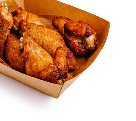 Golden fried chicken wings served in a brown cardboard tray