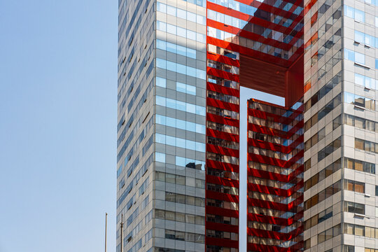 Modern facade detail in Santa Fe, Mexico City, Mexico, combining red structural elements and glass surfaces, representing contemporary architecture and urban identity in residential towers