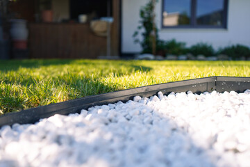 White Pebble Garden Bed with Anthracite Metal Edging and Lawn Background