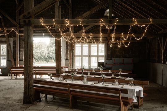 Rustic boho wedding with couple, decorations, flowers and celebration in vintage barn