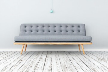 Light gray couch on white wooden floor against a light gray wall, with a teal pendant light