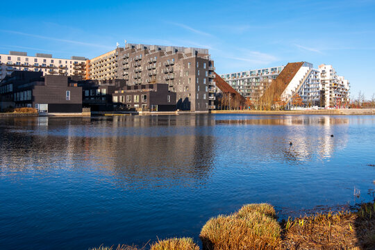 Sustainable urban architecture in Orestad Copenhagen with residential buildings and CopenHill in background, reflecting innovative Scandinavian planning and future housing