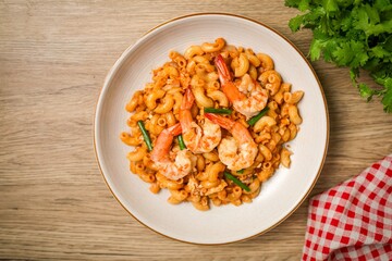 Homemade Stir fried macaroni with shrimp and egg in white plate