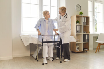 Caregiver or doctor helping disabled woman with walker, supporting during exercise therapy, posing in clinic, undergoes rehabilitation after surgery. Physical therapist teaching supporting exercise