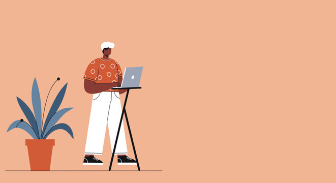 Modern person working efficiently on a laptop at a standing desk, embodying productivity and a flexible remote work lifestyle.