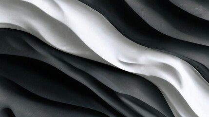 Obraz premium Flowing black, gray, and white fabric creates a calming, abstract wavy pattern