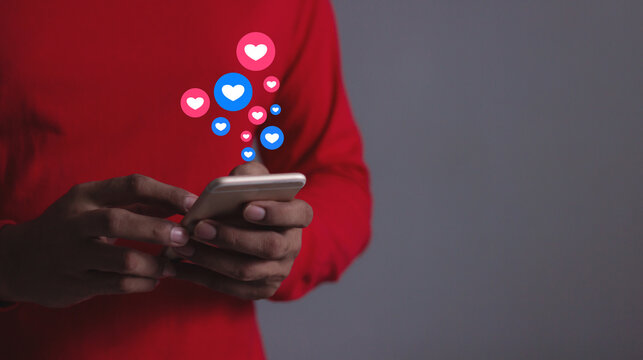 Love And Like Social Media Concept, Young Man hand using smart phone mobile, with Social Media, on soft blurred background