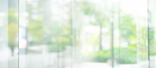 Big window glass building with blur green gaeden.