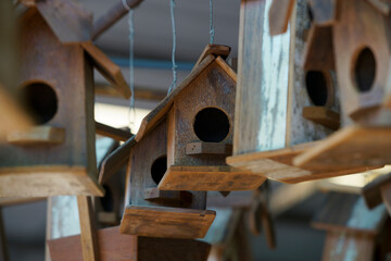 Rustic Wooden Bird Houses Hanging in an Artisan Market Display