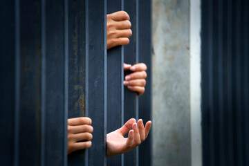 Hands Reaching Through Bars Symbolizing Hope and Despair in Captivity