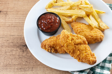 Crispy fried chicken tenders on wooden table