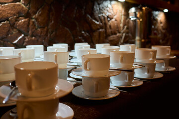 Neatly stacked white coffee cups for elegant events or catering, making a stylish presentation