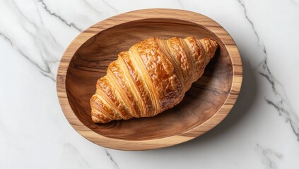 Golden croissant in wooden bowl on marble (34)