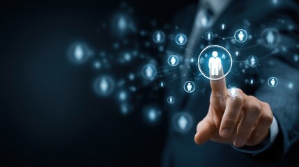 Fototapeta premium Connecting the Dots: A hand interacts with a digital interface, highlighting the concept of networking and connection, visualized with illuminated, interconnected points and human silhouettes.