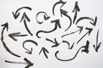 Set of dark arrows drawn with watercolor, different shapes, directions and curves on white background, artistic elements of interface