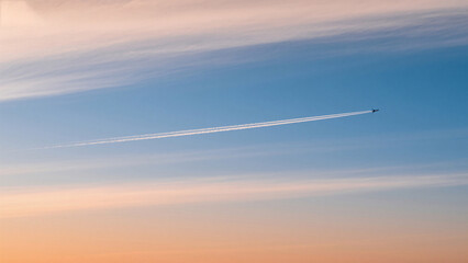 airplane in the sky at sunset