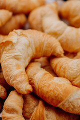 fresh croissant on wooden table, croissants on a wooden table