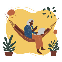 Relaxed senior woman using a laptop and smartphone in a hammock, embracing modern technology and flexible work or leisure.