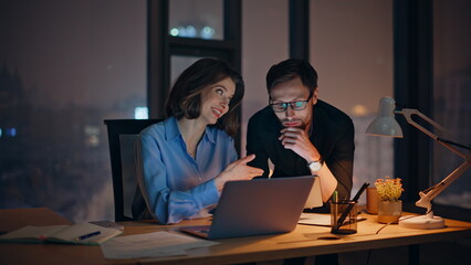 Office coworkers sharing ideas at dark workplace closeup. Smiling woman manager
