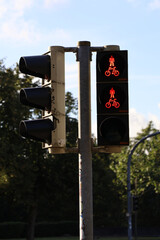 Traffic light showing red signals for pedestrians and cyclists