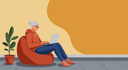 Relaxed senior woman in glasses sits on a bean bag, using a laptop at home. Modern lifestyle, comfortable remote work, or online learning.