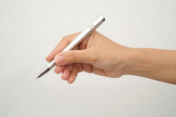 woman's hand holding a grey pen isolated on white background