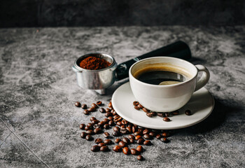 Aromatic Coffee cup and beans with ground coffee on Portafilter, Espresso coffee cup aromatic and making equipment