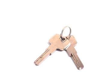 details of key ring with various door and car keys against a white background,