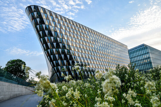 Modern architecture of aula medica at Karolinska Institutet against evening sky