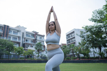 Indian woman practicing yoga in park