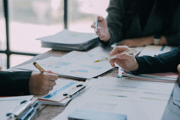 Teams work on project strategy, prepare reports, point to infographics on the conference table. Analyze sales results Do market research, close-up pictures