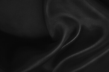 Black fabric cloth texture for background and design art work, beautiful crumpled pattern of silk or linen.