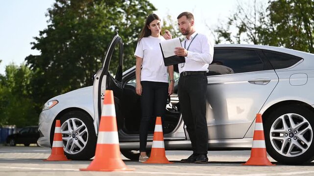 Discussing the results. Woman is trying to pass exam in the driving school.