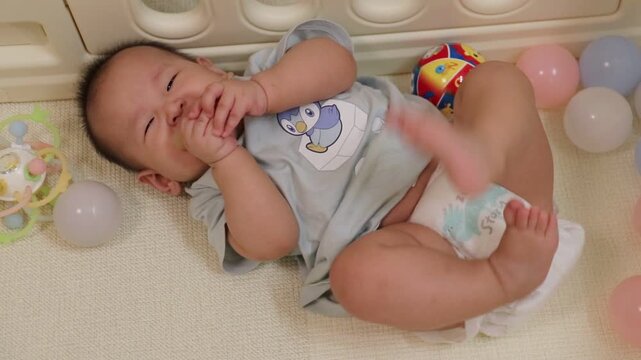 Adorable baby is happily gnawing on a teether