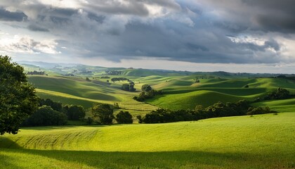 rolling green hills under an overcast sky in a quiet countryside setting with patches of trees and farmland