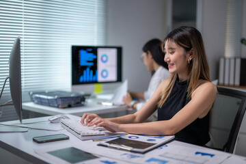Young office worker analyzing marketing data working with desktop computer at modern office