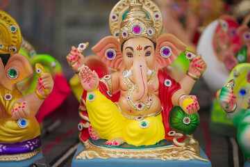 Lord Ganesha idol for Ganesh Chaturthi festival in India, Colorful Ganpati statue Stock Photo, Lord Ganesha murti. 