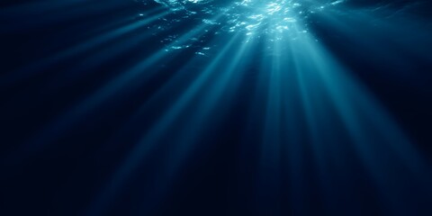 A dark blue background with rays of light shining down, creating an underwater effect. 