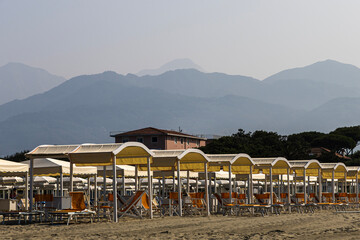 Beach umbrellas and sun loungers at the tourist resort, Tyrrhenian Sea, Viareggio, Italy.