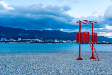 Gelendzhik resort out of season. Empty lifeguard tower on beach of Gelendzhik Bay in winter. There are no people on beach. Twilight.