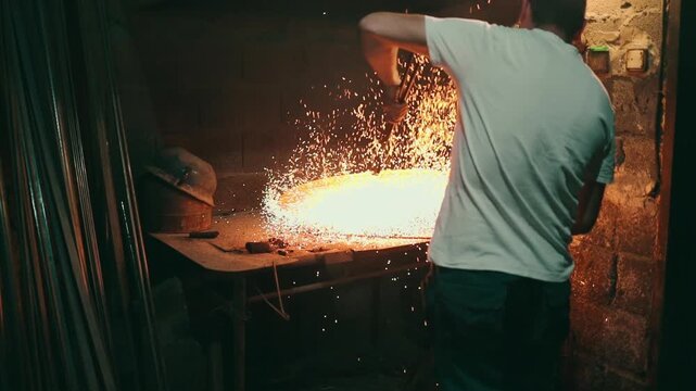 Traditional coppersmith workshop for copper brewing pots manufacturing. This handmade brewery kettles will be used for making traditional alcohol brandy drinks. Small traditional business concept.