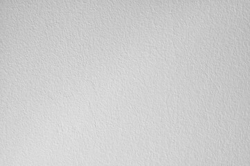 A detailed macro shot of a textured light gray surface with subtle speckling and a grainy appearance creating an abstract background suitable for various design applications