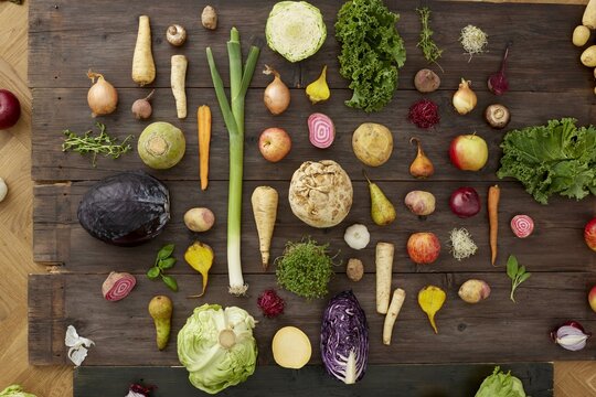 Fresh and colorful variety of vegetables and fruits on a rustic wooden table - Powered by Adobe