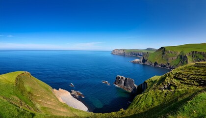 Fototapeta premium scenic coastal cliffs overlooking calm blue ocean on a clear day with rolling green hills