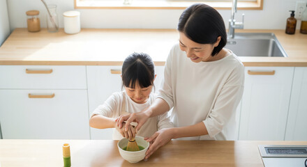 Japanese grandmother teaching granddaughter to whisk matcha tea