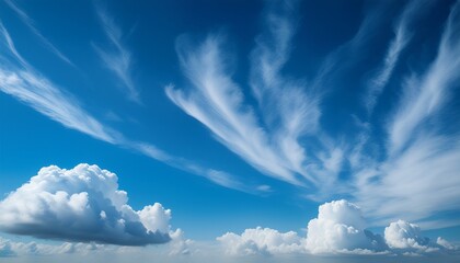 beautiful fluffy clouds in vibrant blue sky with wispy strands of white clouds
