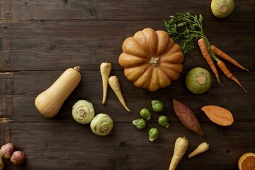 Assortment of fresh vegetables on dark wood table top for harvest season