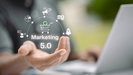 Marketing 5.0 Technology with Businessman Hand and Digital Icon on Laptop